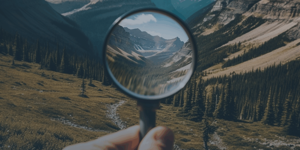 sofiaouchterlony_A_close_up_view_of_a_hand_holding_a_magnifying_7185d46a-1375-4ba9-bdcd-baa72455fc4e navy